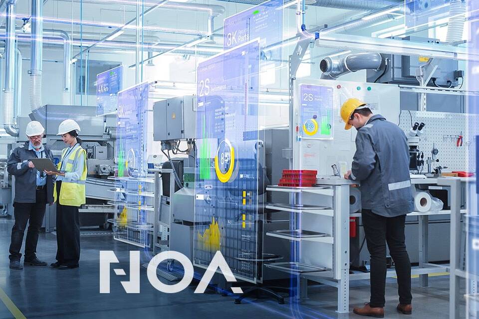 workers in a machine hall at assembly tables with the NOA logo