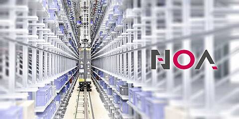 A load-lifting crane in a row of a high-bay warehouse. On the right is the logo of KEB NOA