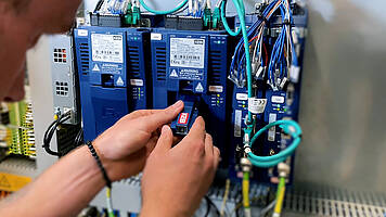 A control cabinet builder plugs the operator into the interface of a COMBIVERT F6 Drive Controller