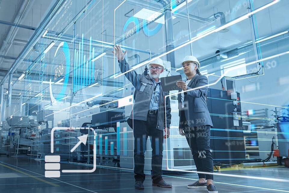 man and woman with safety helmets on in a production hall, looking at a virtual HMI dashboard, a symbol is visible as an overlay