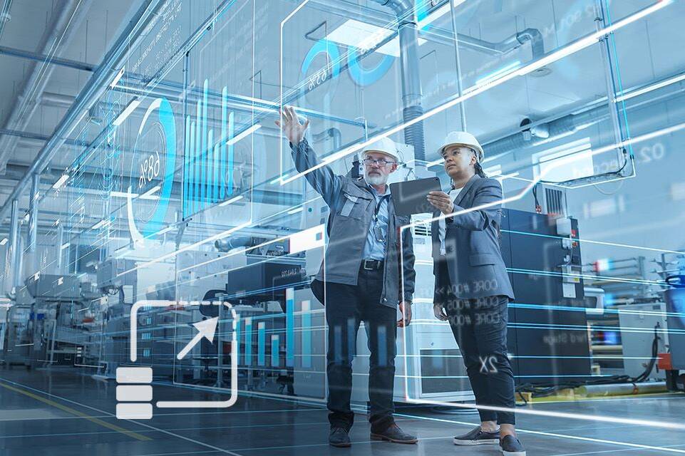 man and woman with safety helmets on in a production hall, looking at a virtual HMI dashboard, a symbol is visible as an overlay