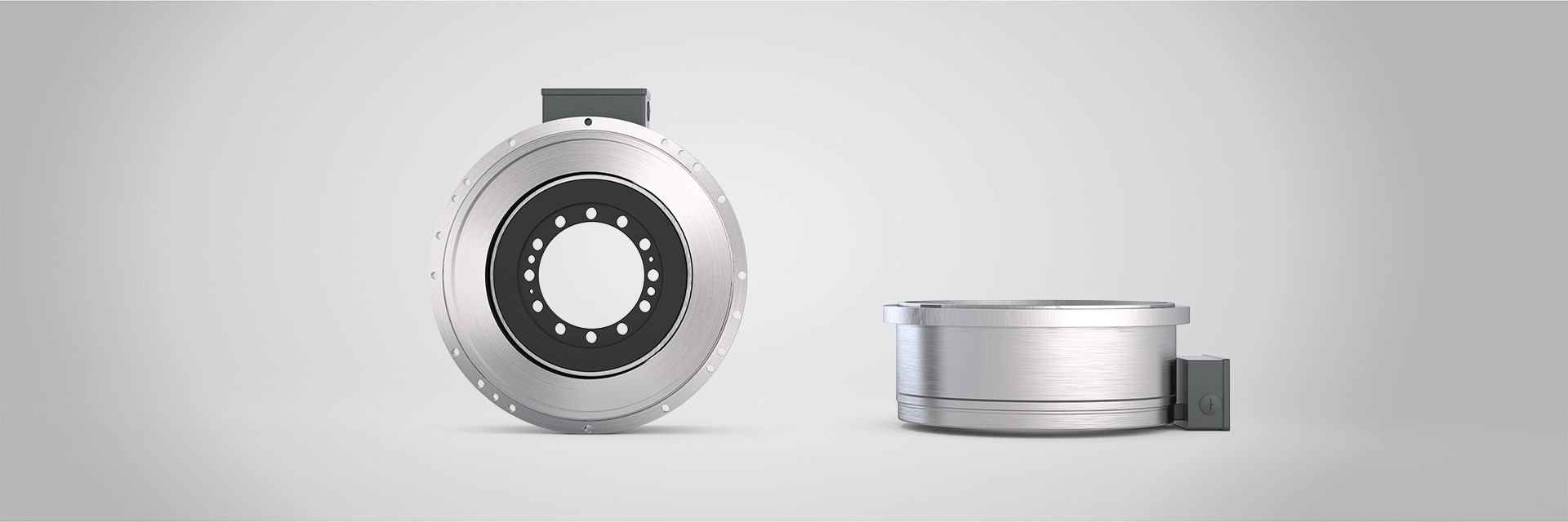 A high-torque motor from the BT series, manufactured by Brusatori, from 2 different angles on a grey background